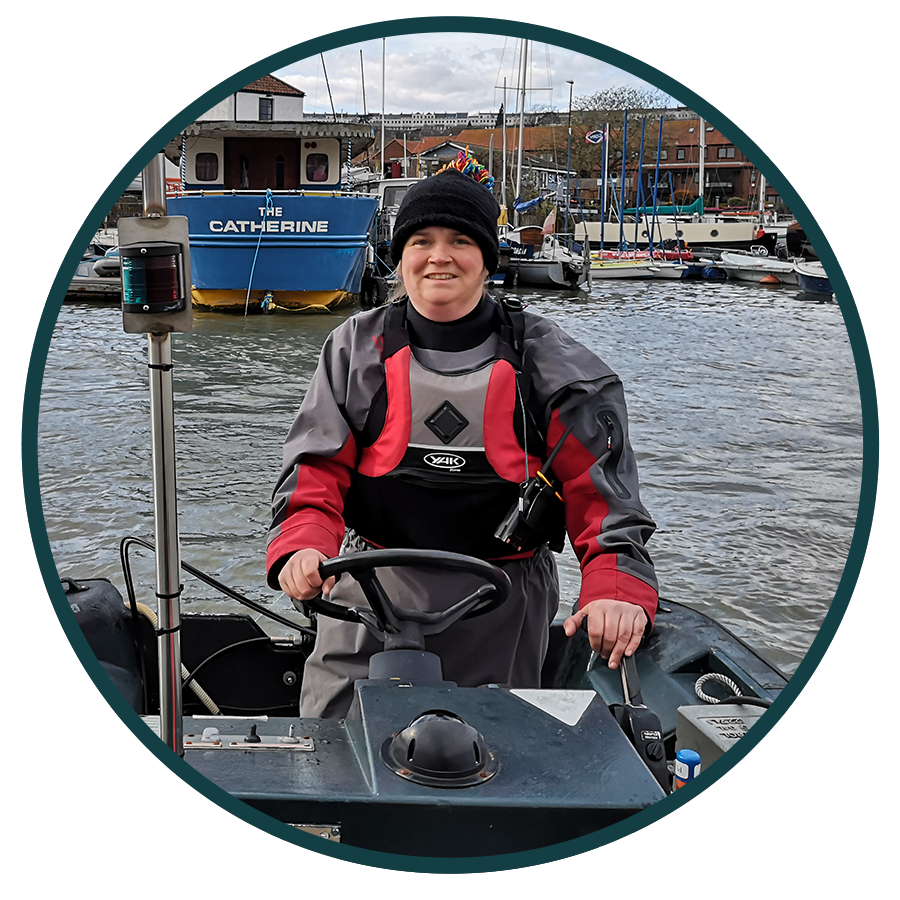 image of a woman steering a boat