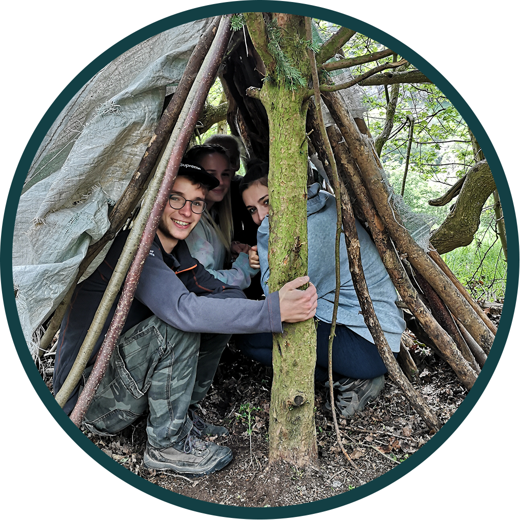 group taking shelter under a makeshift tent