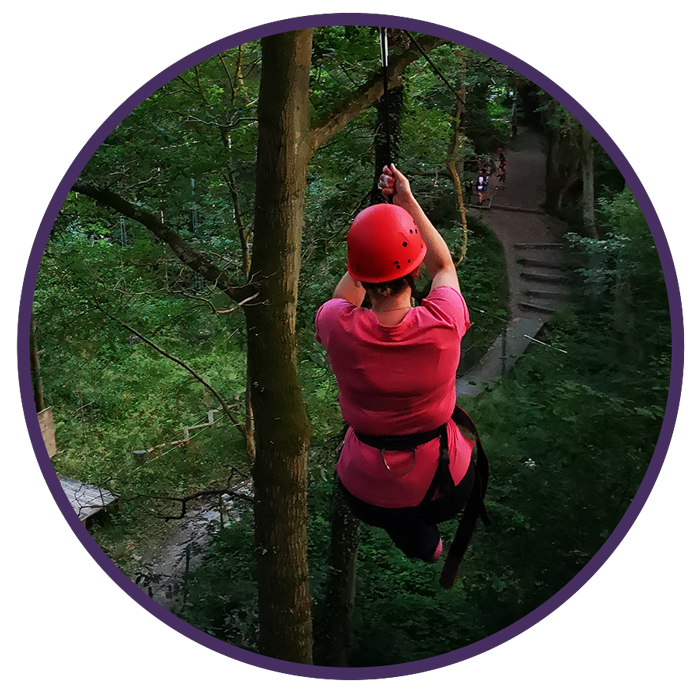 woman in red helmet on a zipline