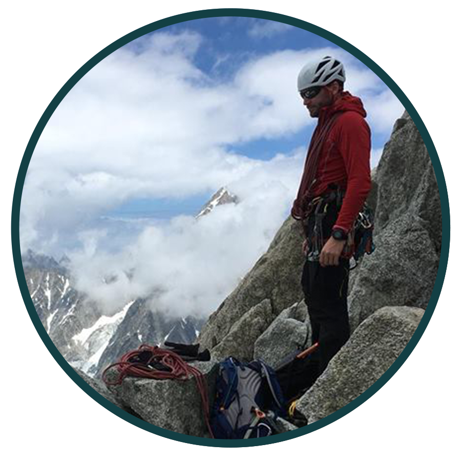 image of man with climbing gear on a mountain