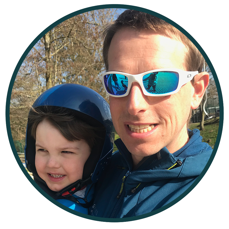 image of man in sunglasses and child in helmet