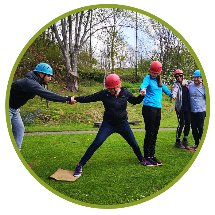 a group wearing helmets in a team building exercise
