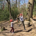 Children on low rope rings